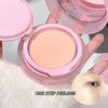 Pink compact with a beige powder, held open to show the product inside.