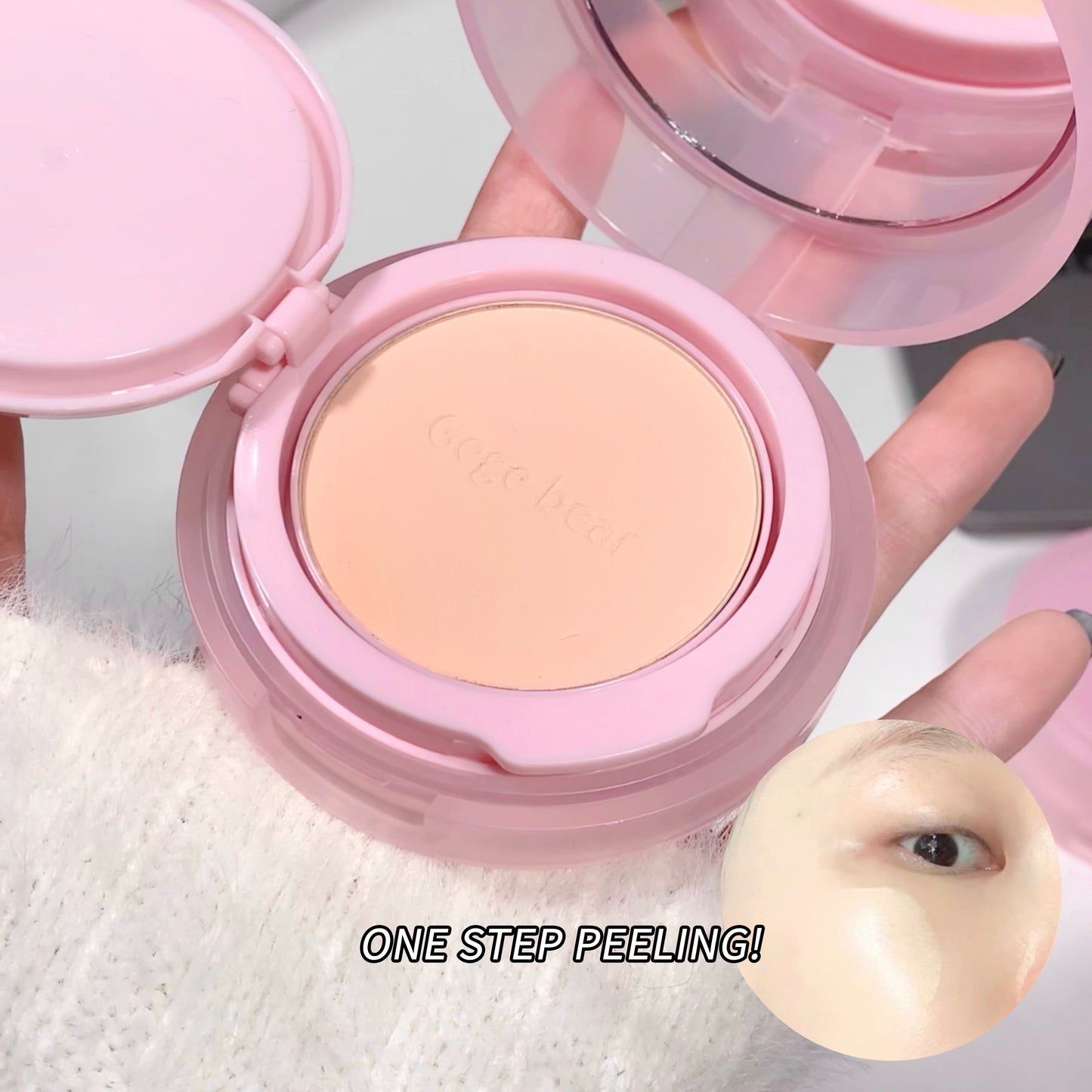 Pink compact with a beige powder, held open to show the product inside.