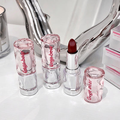 Set of Gege Bear lipsticks on a white surface with a mirror in the background