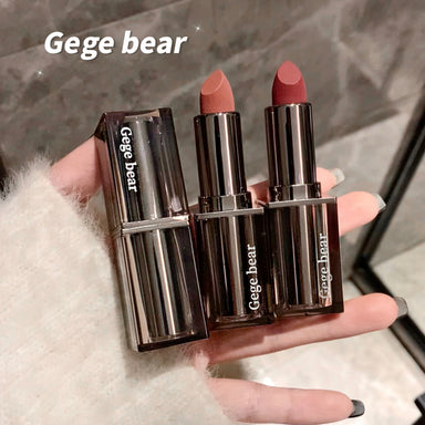 Two lipsticks held in a hand with 'Gege bear' branding.