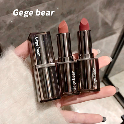 Two lipsticks held in a hand with 'Gege bear' branding.