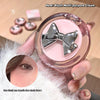 Pink blush multi-purpose cream with a silver bow design held by a hand.