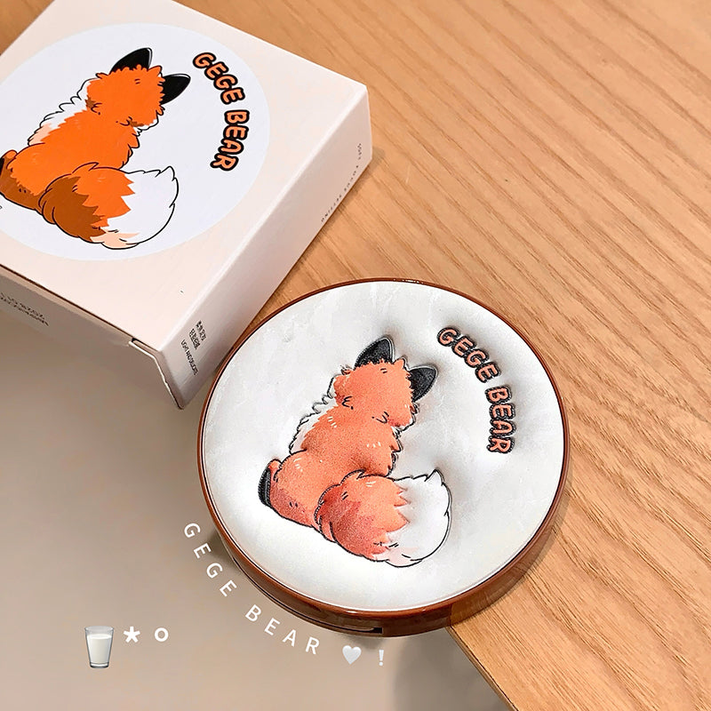 Compact mirror with a fox design and 'GEGE BEAR' branding on a wooden surface.