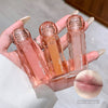 Three small transparent bottles labeled 'Gege bear' held in a hand, with a close-up of lips at the bottom.