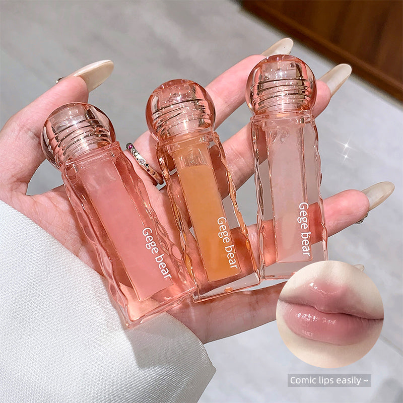 Three small transparent bottles labeled 'Gege bear' held in a hand, with a close-up of lips at the bottom.