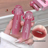 Two pink lip glosses held by a hand with a close-up of lips wearing the product.