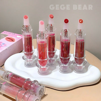 Set of lip glosses on a white stand with 'GEGE BEAR' branding.