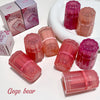 Pink and red containers with 'Gege Bear' branding on a white surface.