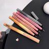Set of GEDE BEAR makeup pens on a black surface with a white background