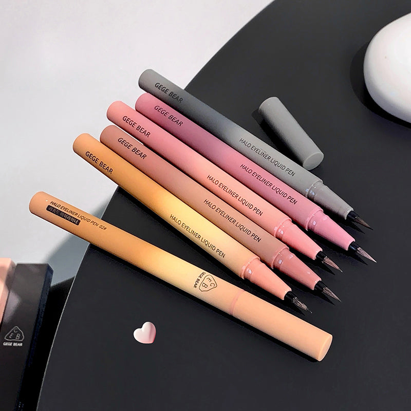 Set of GEDE BEAR makeup pens on a black surface with a white background