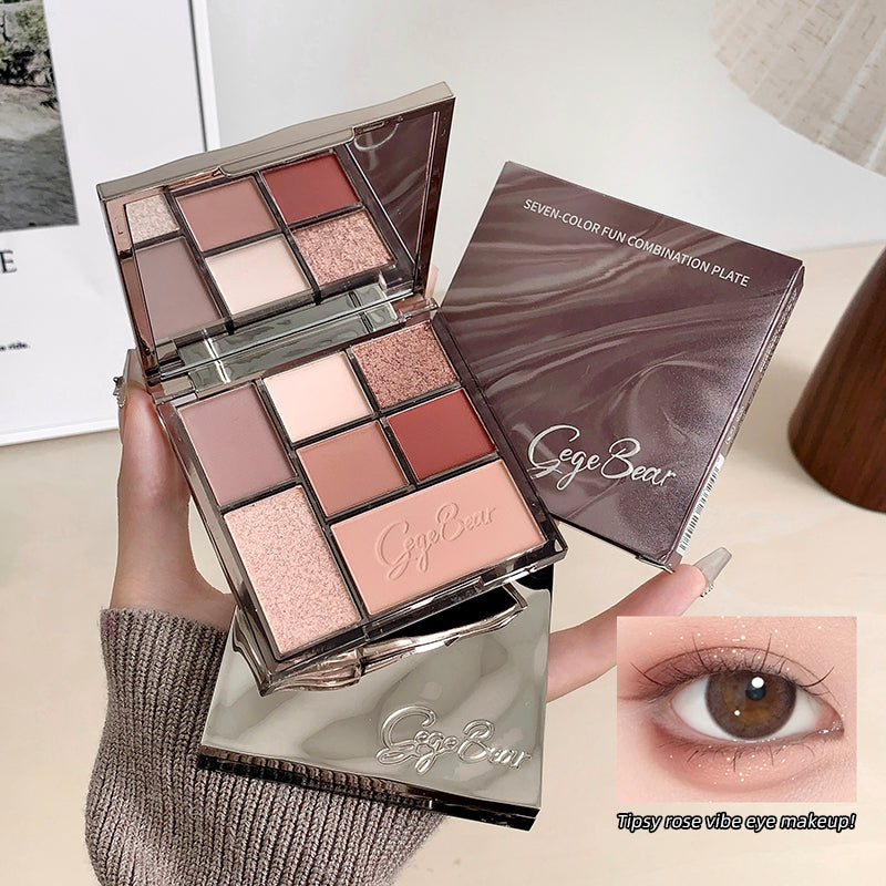 Makeup palette with 'Cige Bear' branding, held by a hand, with an inset of an eye wearing the makeup.