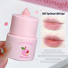 Pink lip balm with peach design and text on a white background