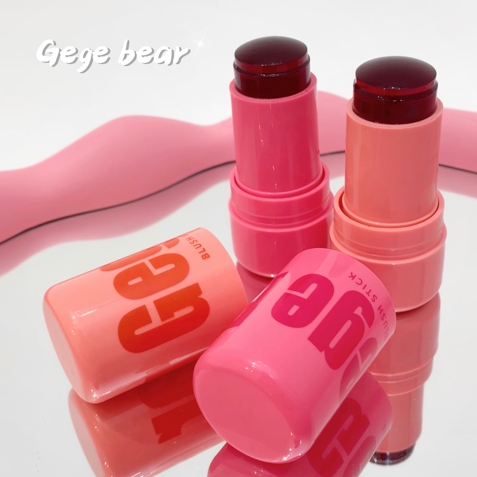 Pink lip balm sticks with 'Gee' branding on a white background