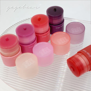 Collection of Gege Bear lip balm containers on a white background