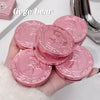 Pink compact mirrors with decorative designs held in a hand, brand 'Gege bear' visible.