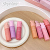 Set of pink and purple lip balms with 'Gege Bear' branding on a wooden surface.