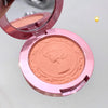 Compact blush in a pink case on a light gray background