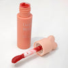 Pink lip balm with a visible brand name on a white background