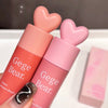 Two Gege Bear lip products with heart-shaped caps on a white surface.