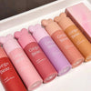Set of Gege Bear lip glosses in various colors on a white surface.