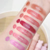 Lipstick swatches on a person's arm with brand names visible