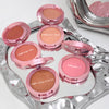 Set of pink makeup blushes with visible color names on a silver tray