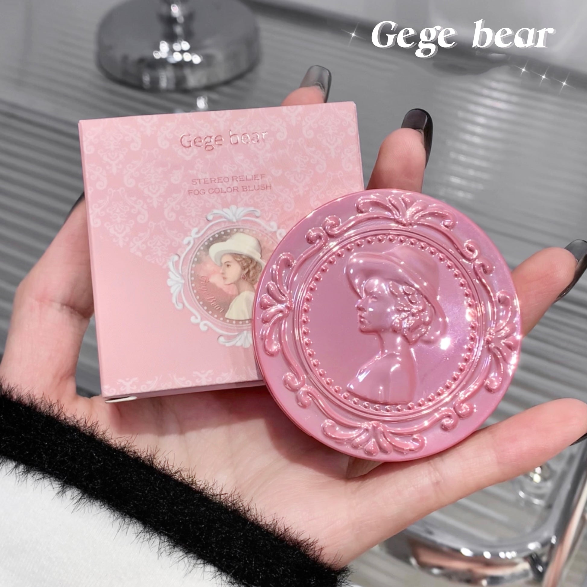 Pink decorative soap with embossed design held by a hand