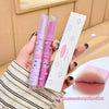 Two lip glosses and their packaging held by a hand, with a close-up of lips shown.