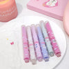 Set of six colorful pens with cartoon designs on a white plate.