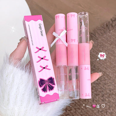 Set of pink lip products with packaging held by a hand on a textured surface.