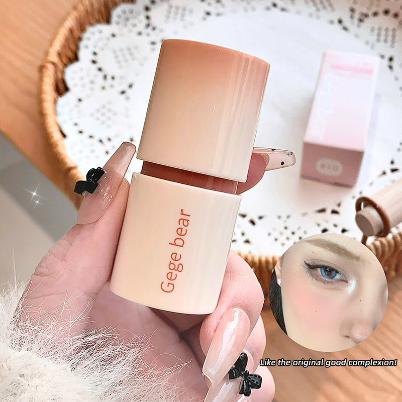 Hand holding a Gege bear cosmetic product with a blurred background