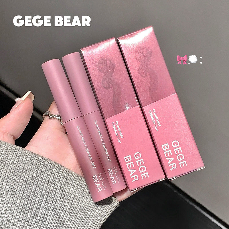 Pink GEGE BEAR makeup products held by a hand against a dark background