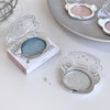 Compact powder cases with different shades on a white surface