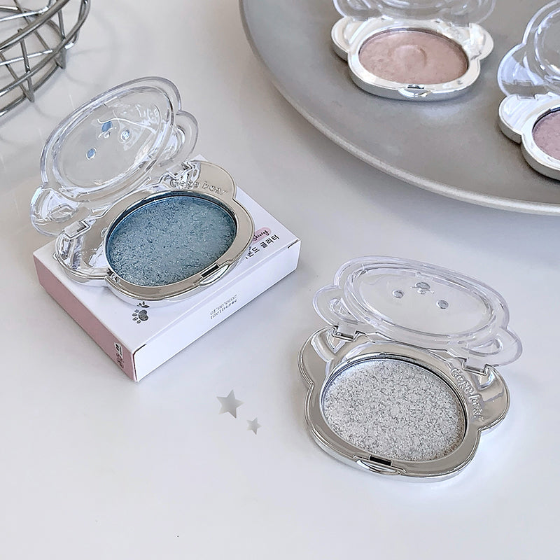 Compact powder cases with different shades on a white surface