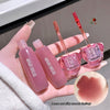 Pink lip gloss with applicators held by a hand, close-up of gloss texture.