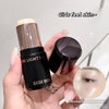 Hand holding a makeup product with 'GEGE BEAR' branding and text overlay on a neutral background.
