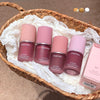 Set of Gege Bear lip and cheek multi-purpose creams in various shades on a textured surface.