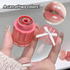 Lip balm with pink container and clear cap held by a hand, with close-up of lip color.