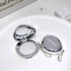 Compact mirror with glittery powder and 'Geege bear' branding on a white surface.