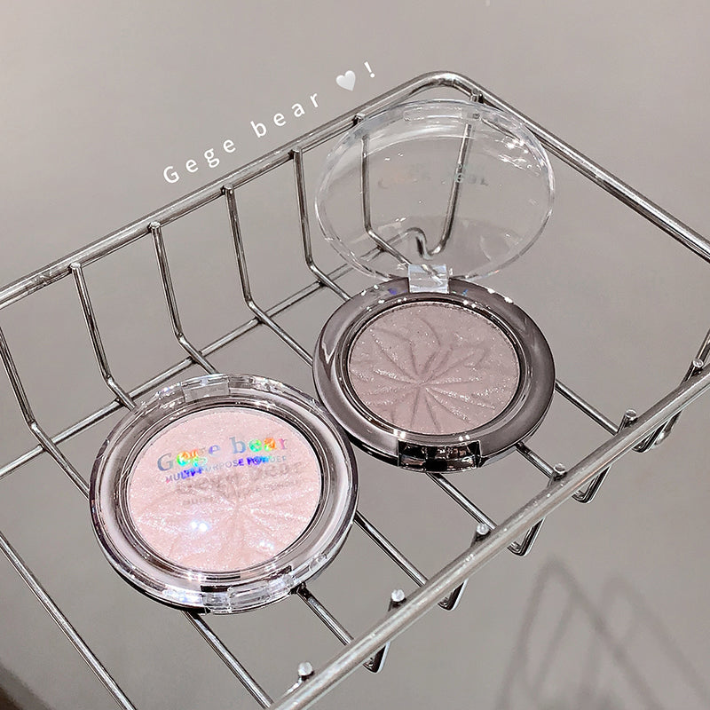Compact powder with 'Geege bear' branding on a metal rack.