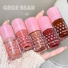 Set of Gege Bear nail polishes held in a hand with a white lace background