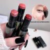 Hand holding four lipsticks with close-up of a lip and text overlay on a blurred background