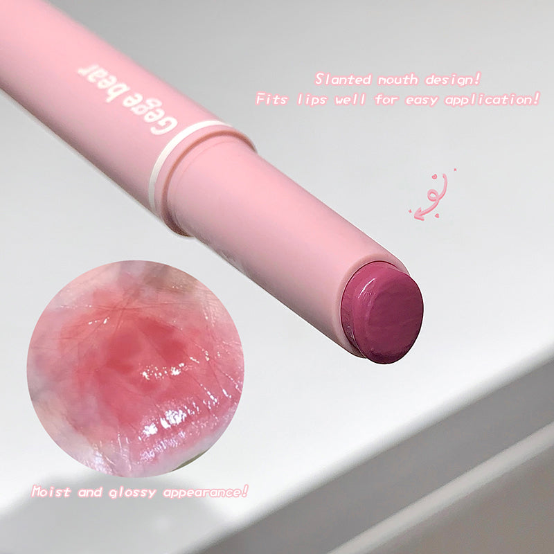 Pink lip balm with visible brand name on a light gray background