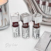 Three Gege Bear lip glosses with silver caps on a white surface.