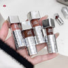 Four lip glosses from the brand 'Gige Bear' held in a hand with a blurred background.