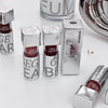Silver lip gloss bottles with 'GEGEBEAR' branding on a white surface.