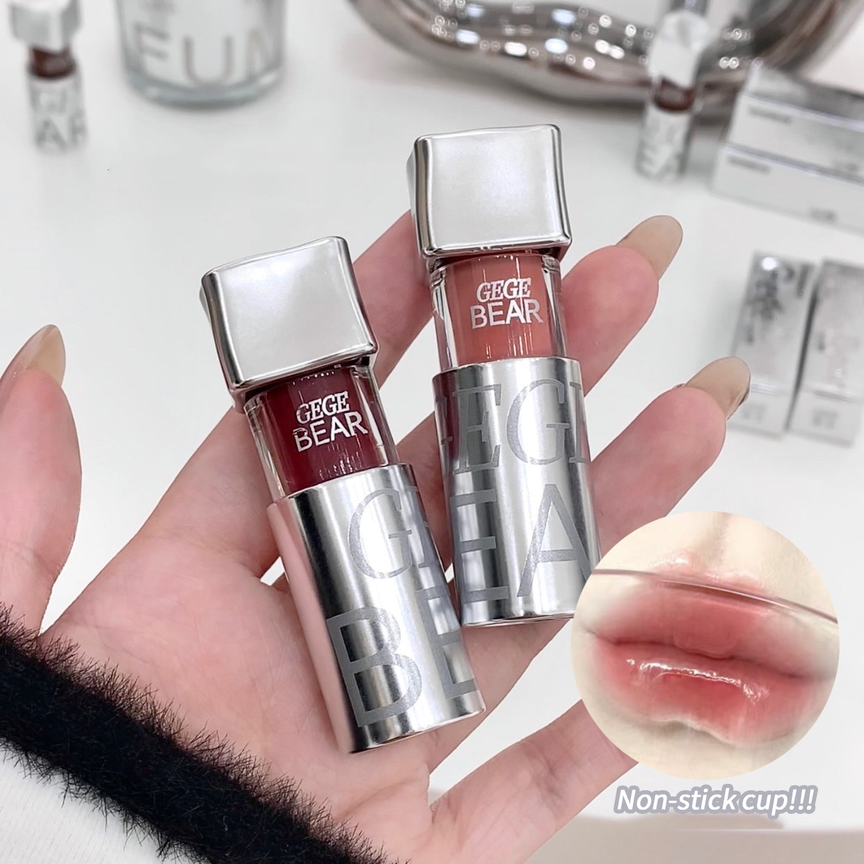 Three GECE BEAR lip glosses held in a hand with a close-up of a glossy lip.