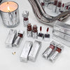 Collection of GEGEREAR lip products including lipsticks and lip glosses on a white surface with a candle and mirror.