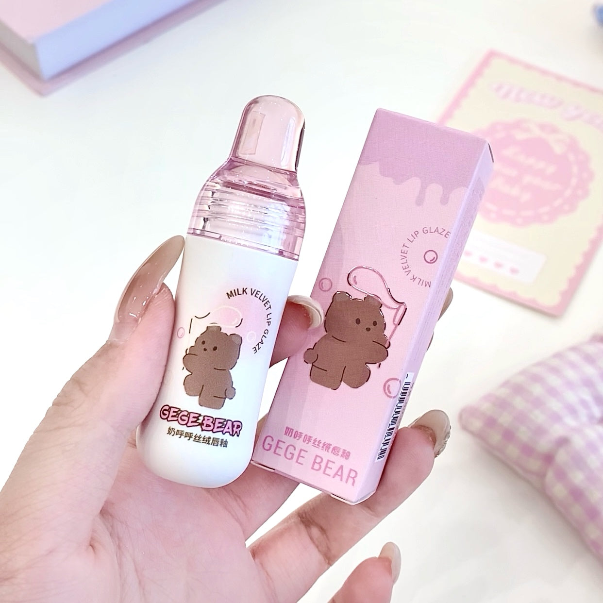 Hand holding a GEGER BEAR product with packaging on a light background
