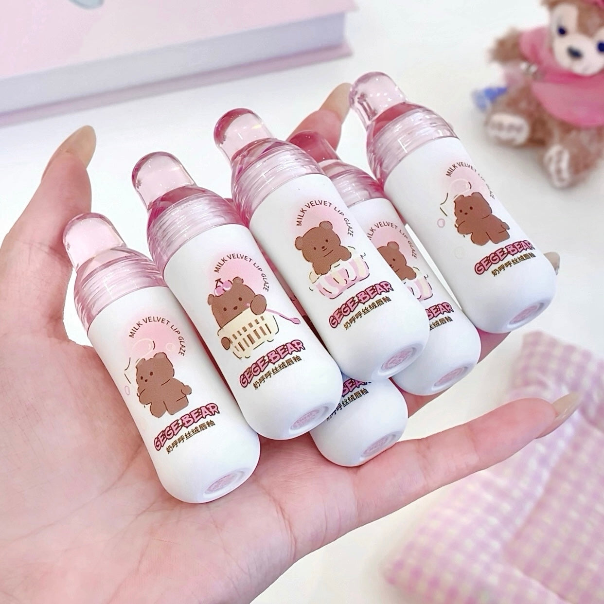 Set of small bottles with bear designs held in a hand